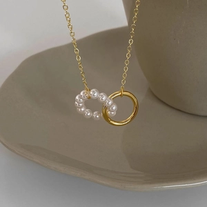 French luxury 18k gold plated titanium necklace with pearl circle pendant in ceramic tray