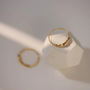Minimalist gold-plated beaded ring with geometric cube charms on a textured band