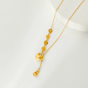 Golden lotus tassel necklace featuring longevity lock and blessing coins on a minimal background