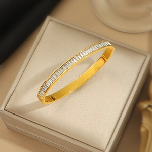 Elegante bracciale rigido in acciaio al titanio dorato con zirconi rettangolari brillanti