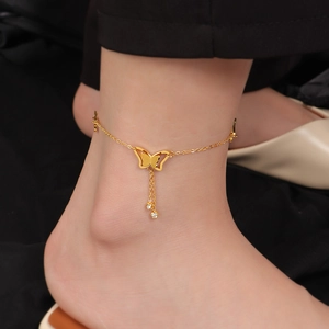 Elegante cavigliera a farfalla in acciaio al titanio dorato con nappine di strass