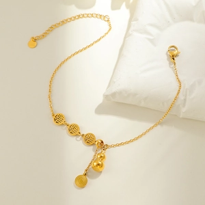 Golden gourd and blessing character anklet on white stone minimalist background