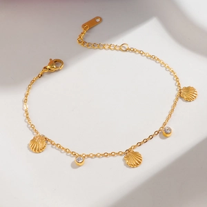 Gold-plated stainless steel bracelet featuring seashell charms and sparkling zircon stones