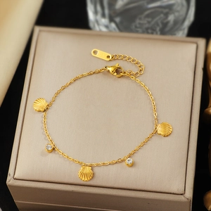 Elegant 18K gold plated shell charm bracelet with sparkling zircons on jewelry box