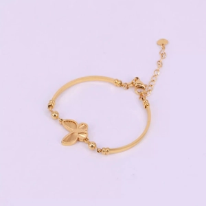 Elegant gold butterfly bracelet with curved bars and adjustable heart pendant chain