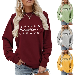 Close-up of MAKE HEAVEN CROWDED letter print and heart graphic on soft knit sweatshirt