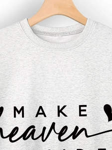 Detail of ribbed neckline and 'MAKE heaven' print on light grey heathered sweatshirt