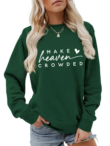 Close-up of 'Make Heaven Crowded' white text print on deep green cotton sweatshirt