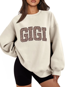 Detailed close-up of leopard print GIGI letters on a thick beige oversized sweatshirt