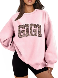 Close-up of pink oversized sweatshirt featuring leopard print GIGI block lettering