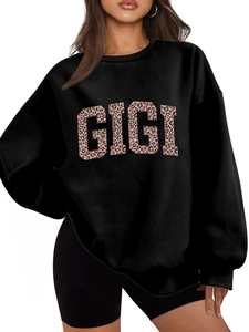 Detail of GIGI leopard print lettering and ribbed cuffs on black oversized sweatshirt