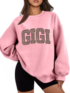 Close-up of GIGI leopard print lettering on a pink oversized long-sleeve sweatshirt