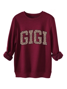 Detail of burgundy sweatshirt showing ribbed cuffs and textured leopard print GIGI logo
