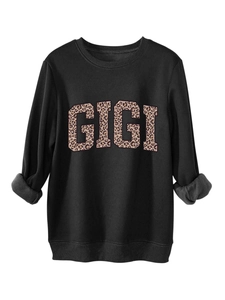 Close-up of black GIGI sweatshirt with leopard print letters and grey fleece lining