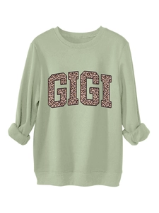Macro shot of GIGI leopard print detail on sage green crewneck sweatshirt fabric