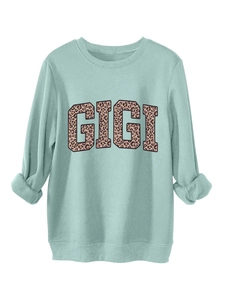 Detail of mint green sweatshirt with leopard print GIGI lettering and ribbed cuffs