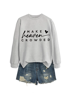 Detail of grey crewneck sweatshirt with Make Heaven Crowded print and distressed denim shorts