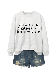 Detail of grey sweatshirt with Make Heaven Crowded print and distressed denim shorts