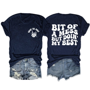 Flat lay of navy blue crew neck T-shirt featuring 'Bit of a mess' print detail and texture