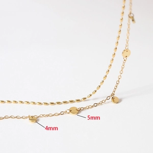 Double layered gold anklet featuring 4mm and 5mm circular charms in titanium steel
