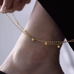 Double-layered gold anklet with delicate beads and round disc charms in stainless steel
