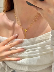 Detailed view of a gold-plated double-layer necklace with 3D rose flower and long tassels