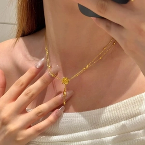 Golden 3D rose flower pendant necklace with elegant double layer chain on model