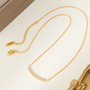 Elegant 18K gold smile necklace with shimmering zircons on a delicate O-chain