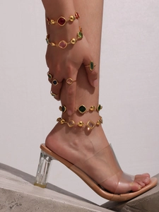 Detailed view of layered 18K gold-plated anklets with colorful geometric crystal gemstones