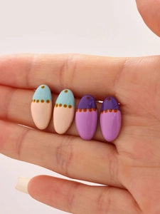 Detail of 18k gold-plated oval enamel earrings with colorful oil painting patterns