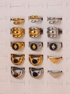 Detail view of various stainless steel rings with tiger eye and black onyx in a box