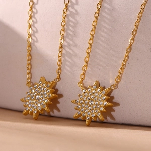 Elegant gold sunburst pendant necklace set with sparkling 5A cubic zirconia stones