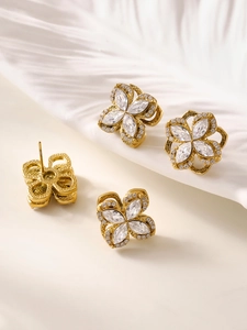 Detail view of 18K gold plated clover stud earrings with sparkling marquise cut zircons