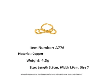 Detailed view of copper bow-shaped ring in 18K gold finish with measurement specs