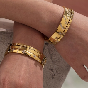 Golden stainless steel geometric bangles set with star and heart zircon engravings