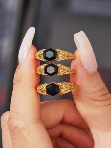 Macro view of 18k gold plated octagonal ring with black onyx and vintage engravings