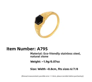 Macro detail of 18k gold plated ring featuring vintage patterns and black natural stone