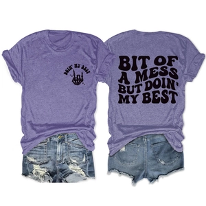 Detail of purple cotton T-shirt with 'Bit of a mess' print and ripped denim shorts