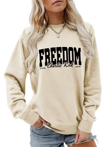 Detailed view of cream sweatshirt with bold black Freedom Charlie Kirk graphic print