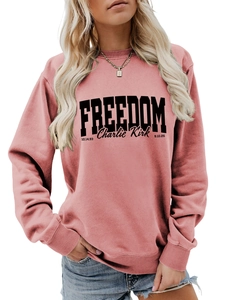 Detailed shot of the pink crewneck sweatshirt with Freedom Charlie Kirk letter printing