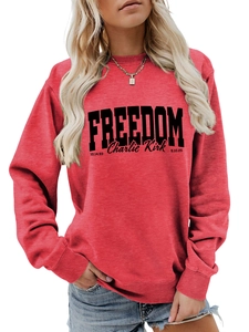 Detail view of red crewneck sweatshirt with black Freedom and Charlie Kirk printed text