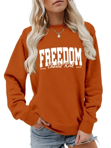 Close-up of Freedom Charlie Kirk letter print on orange long sleeve cotton sweatshirt