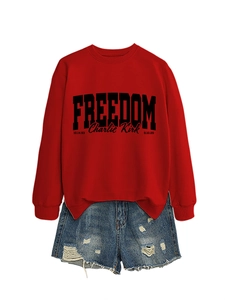 Detail of red Freedom Charlie Kirk sweatshirt paired with distressed denim shorts