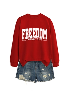 Detail of red Freedom Charlie Kirk sweatshirt paired with distressed blue denim shorts