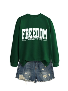 Detail view of freedom charlie kirk sweatshirt with white typography on green fabric