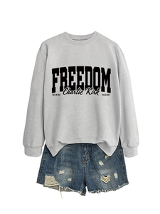 Detail of grey crewneck sweatshirt featuring black Freedom and Charlie Kirk text print