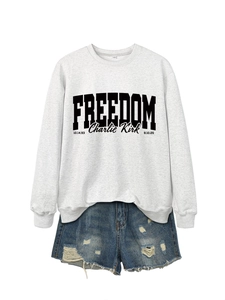 Detail of grey Freedom Charlie Kirk sweatshirt neckline with S size label and black text