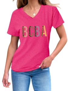 Close-up of rose red V-neck T-shirt featuring leopard print BCBA lettering and soft texture