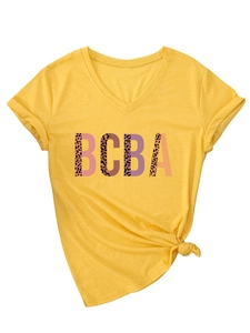 Detail of yellow V-neck t-shirt featuring leopard print BCBA lettering and hem knot