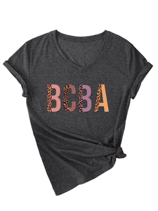 Detail of dark gray V-neck T-shirt featuring leopard print BCBA lettering and knotted hem